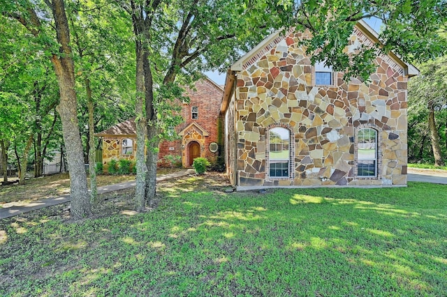 109 Lauren Ln, Pottsboro, TX 75076 - view of front of home featuring stone siding, a front lawn, and brick siding