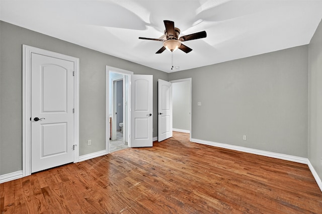 109 Lauren Ln, Pottsboro, TX 75076 - unfurnished bedroom with wood finished floors, ensuite bath, and ceiling fan