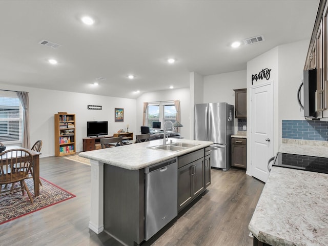 3100 Singleton Rd, Forney, TX 75126 - kitchen with appliances with stainless steel finishes, backsplash, open floor plan, light countertops, and dark wood-type flooring