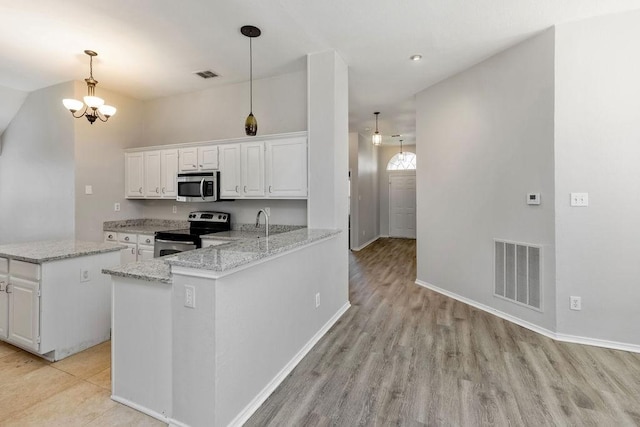5006 Baton Rouge Blvd, Frisco, TX 75035 - kitchen featuring appliances with stainless steel finishes, white cabinetry, light wood finished floors, light stone counters, and vaulted ceiling
