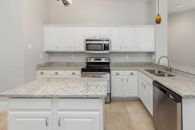 5006 Baton Rouge Blvd, Frisco, TX 75035 - kitchen featuring appliances with stainless steel finishes, white cabinetry, light stone countertops, and a center island