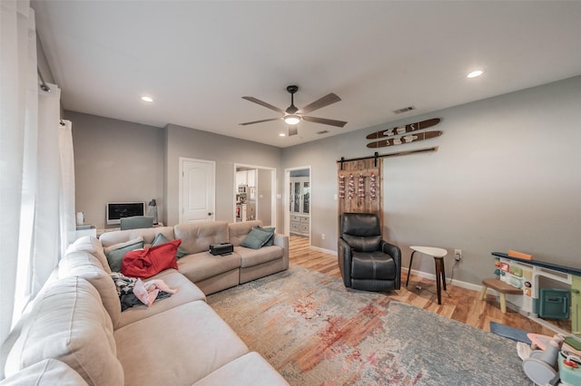 1020 Water St, Waxahachie, TX 75165 - living area featuring a barn door, wood finished floors, a ceiling fan, and recessed lighting