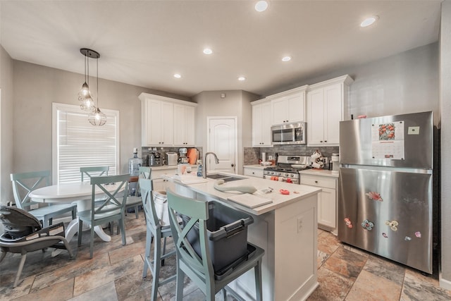1020 Water St, Waxahachie, TX 75165 - kitchen with appliances with stainless steel finishes, stone tile flooring, backsplash, light countertops, and recessed lighting