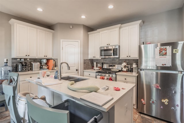 1020 Water St, Waxahachie, TX 75165 - kitchen featuring appliances with stainless steel finishes, tasteful backsplash, light countertops, recessed lighting, and white cabinetry