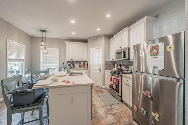1020 Water St, Waxahachie, TX 75165 - kitchen with appliances with stainless steel finishes, backsplash, recessed lighting, light countertops, and white cabinets