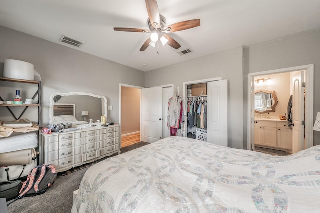 1020 Water St, Waxahachie, TX 75165 - carpeted bedroom featuring two closets, connected bathroom, and ceiling fan