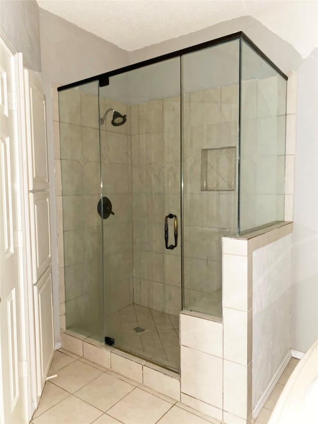 8400 Hickory St Unit 2902, Frisco, TX 75034 - bathroom featuring tile patterned floors and a stall shower