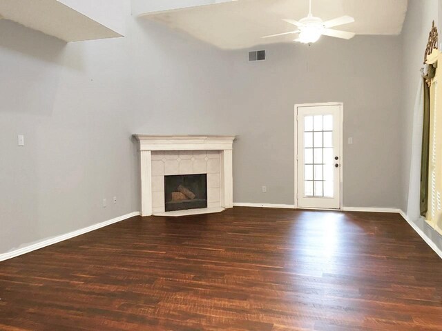 8400 Hickory St Unit 2902, Frisco, TX 75034 - unfurnished living room featuring ceiling fan, high vaulted ceiling, wood finished floors, and a tiled fireplace
