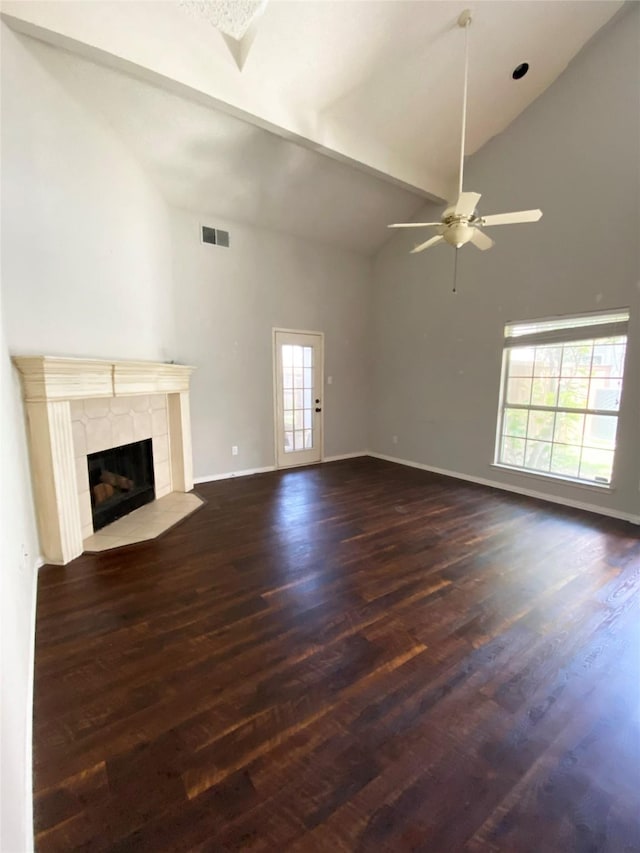 8400 Hickory St Unit 2902, Frisco, TX 75034 - unfurnished living room with ceiling fan, a tiled fireplace, dark wood-style floors, and high vaulted ceiling