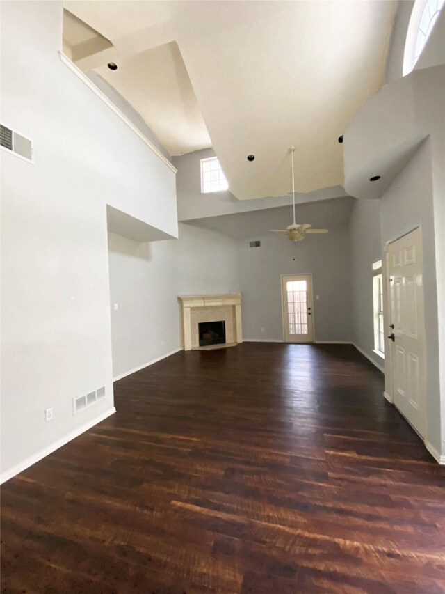 8400 Hickory St Unit 2902, Frisco, TX 75034 - unfurnished living room featuring high vaulted ceiling, a fireplace, plenty of natural light, wood finished floors, and a ceiling fan