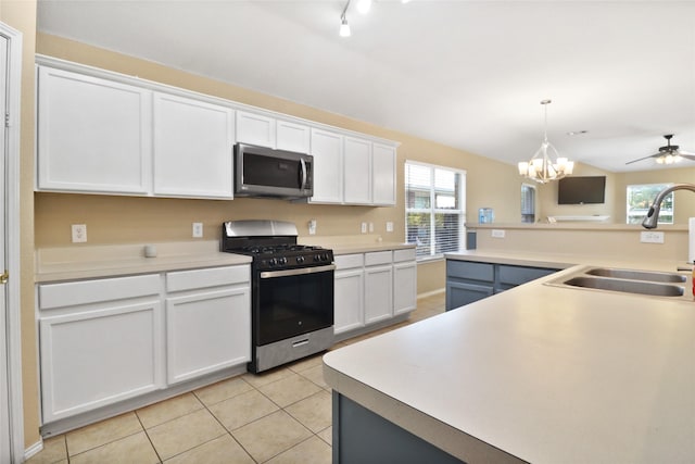 8436 Minturn Dr, Fort Worth, TX 76131 - kitchen with stainless steel appliances, light tile patterned floors, white cabinetry, light countertops, and hanging light fixtures