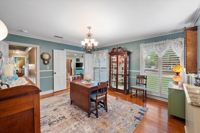 1121 W 3rd Ave, Corsicana, TX 75110 - home office featuring crown molding, a chandelier, and light wood-style flooring