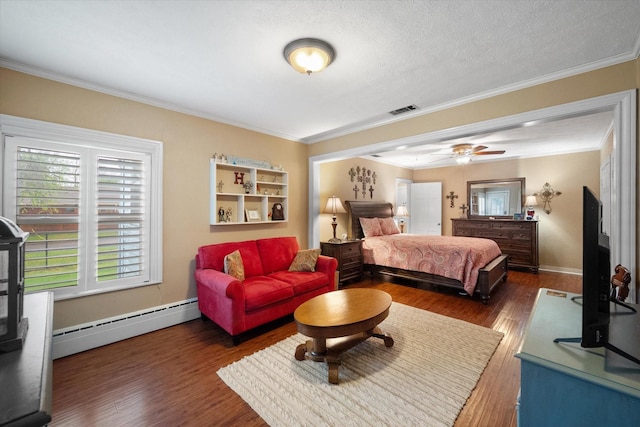 1121 W 3rd Ave, Corsicana, TX 75110 - bedroom featuring a baseboard radiator, wood finished floors, and ornamental molding