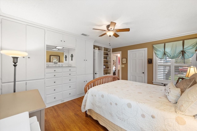 1121 W 3rd Ave, Corsicana, TX 75110 - bedroom featuring light wood-type flooring, crown molding, and ceiling fan