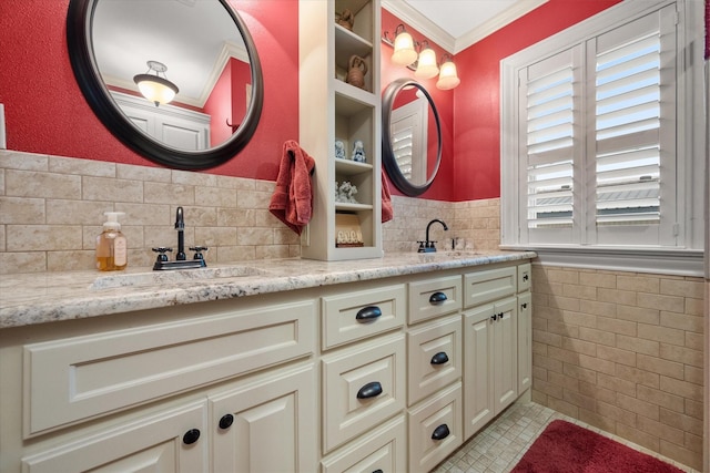 1121 W 3rd Ave, Corsicana, TX 75110 - bathroom with tile walls, double vanity, a wainscoted wall, ornamental molding, and tile patterned flooring