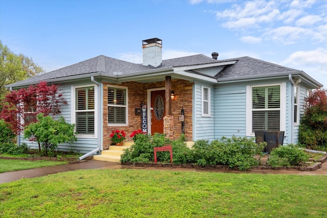 1121 W 3rd Ave, Corsicana, TX 75110 - view of front of home with a chimney, a front lawn, a shingled roof, and stone siding