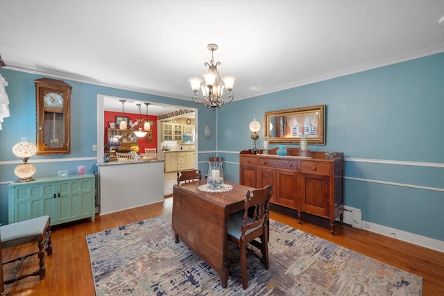 1121 W 3rd Ave, Corsicana, TX 75110 - dining area with a chandelier, ornamental molding, and wood finished floors