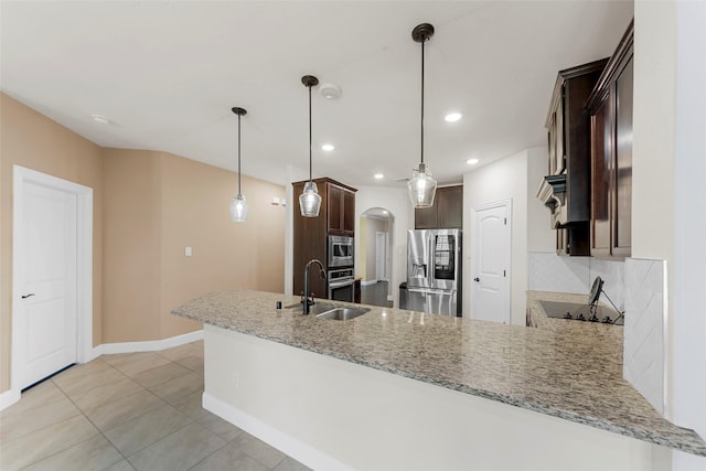 641 Woodridge Dr, Oak Point, TX 75068 - kitchen featuring stainless steel appliances, dark brown cabinetry, tasteful backsplash, light stone counters, and recessed lighting