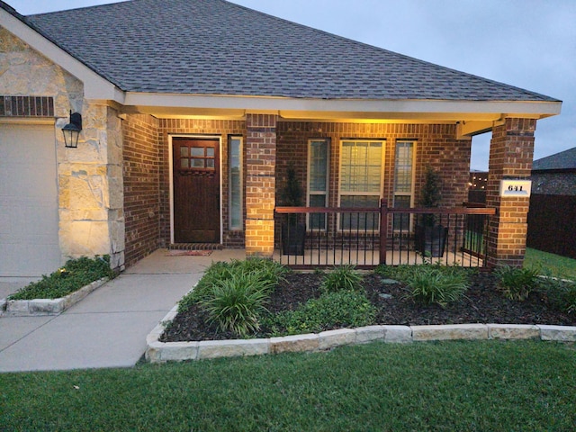 641 Woodridge Dr, Oak Point, TX 75068 - property entrance featuring a shingled roof, covered porch, and brick siding