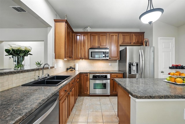 2509 Creek Villas Dr, Bedford, TX 76022 - kitchen featuring appliances with stainless steel finishes, dark countertops, decorative backsplash, and brown cabinetry