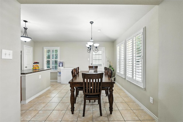 2509 Creek Villas Dr, Bedford, TX 76022 - dining space featuring light tile patterned flooring, a chandelier, and washer / clothes dryer