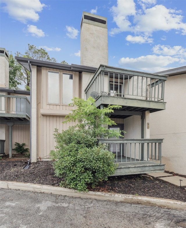 9999 Boat Club Rd Unit 107, Fort Worth, TX 76179 - rear view of property with a chimney and a balcony