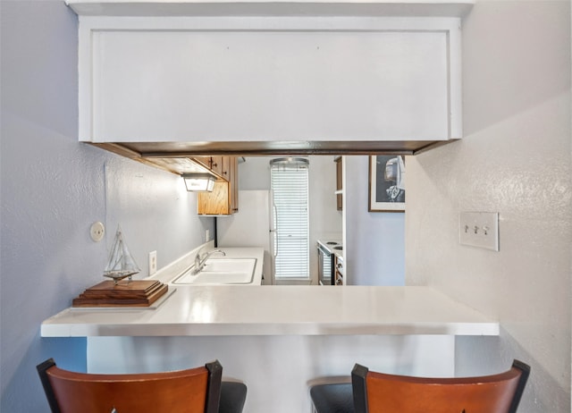 9999 Boat Club Rd Unit 107, Fort Worth, TX 76179 - kitchen with a textured wall and a kitchen breakfast bar