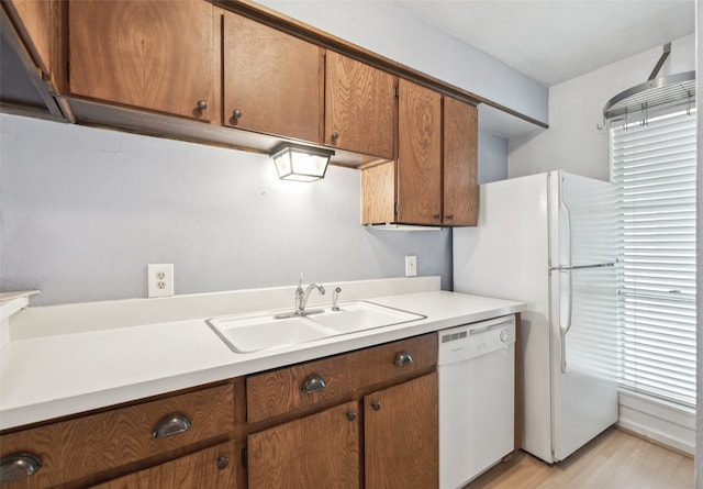 9999 Boat Club Rd Unit 107, Fort Worth, TX 76179 - kitchen featuring white appliances, light countertops, light wood-type flooring, and brown cabinets