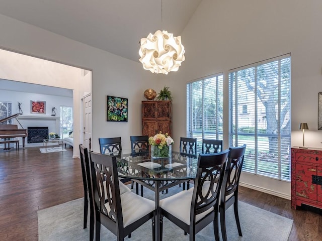 4597 Hallmark Dr, Plano, TX 75024 - dining area featuring a chandelier, plenty of natural light, wood finished floors, and a fireplace