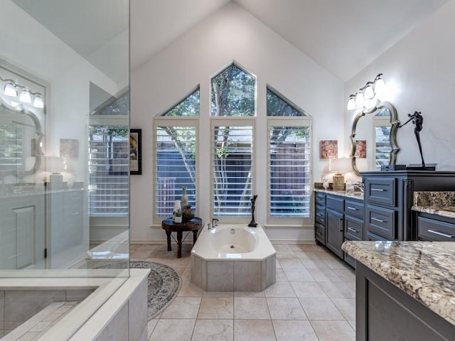 4597 Hallmark Dr, Plano, TX 75024 - full bath with vaulted ceiling, vanity, a garden tub, an enclosed shower, and tile patterned floors