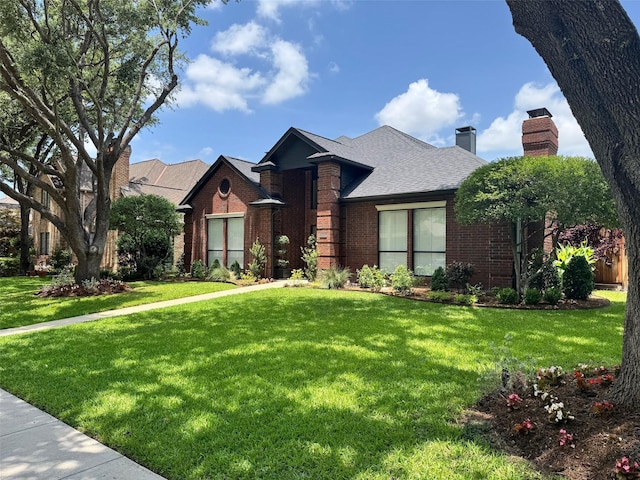 4597 Hallmark Dr, Plano, TX 75024 - view of front of house featuring brick siding, a front lawn, a chimney, and a shingled roof