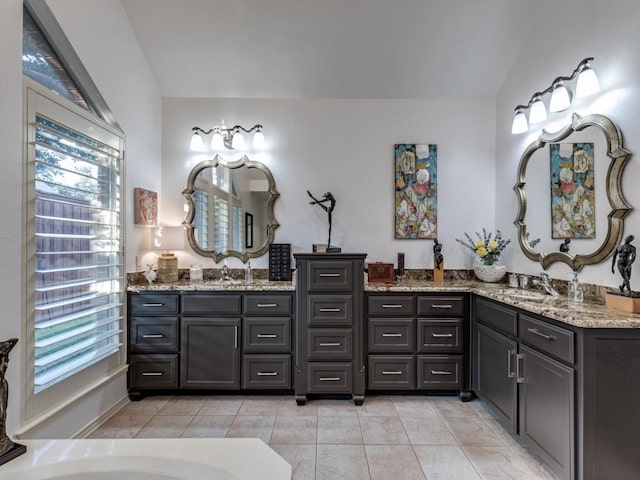 4597 Hallmark Dr, Plano, TX 75024 - full bathroom featuring healthy amount of natural light, vanity, lofted ceiling, a tub to relax in, and tile patterned floors