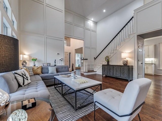 4597 Hallmark Dr, Plano, TX 75024 - living area with a high ceiling, stairs, dark wood-type flooring, recessed lighting, and a decorative wall