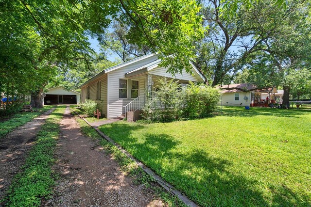 110 Woodland Ave, Corsicana, TX 75110 - view of green lawn with an outbuilding and a detached garage