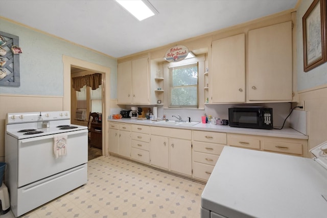 110 Woodland Ave, Corsicana, TX 75110 - kitchen with white electric stove, black microwave, light countertops, open shelves, and cream cabinetry