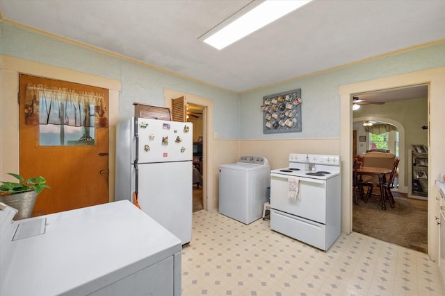 110 Woodland Ave, Corsicana, TX 75110 - kitchen with white appliances, washer / dryer, light flooring, light countertops, and a ceiling fan