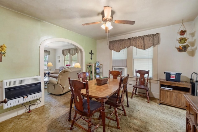 110 Woodland Ave, Corsicana, TX 75110 - dining space with heating unit, arched walkways, a ceiling fan, and light colored carpet