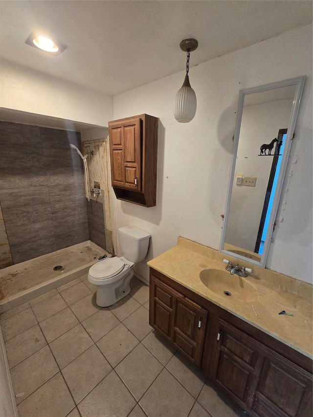 3706 Greenhill Ln, Grand Prairie, TX 75052 - bathroom featuring tile patterned floors, tiled shower, and vanity