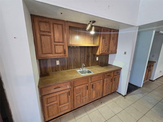 3706 Greenhill Ln, Grand Prairie, TX 75052 - kitchen featuring brown cabinetry, light tile patterned flooring, and open shelves