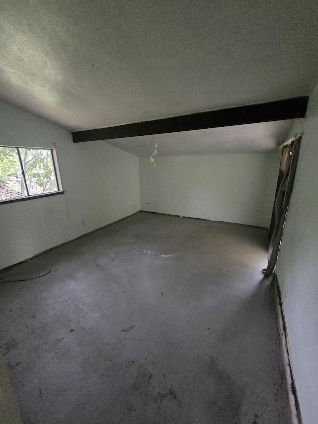 3706 Greenhill Ln, Grand Prairie, TX 75052 - spare room with concrete floors, a textured ceiling, and lofted ceiling