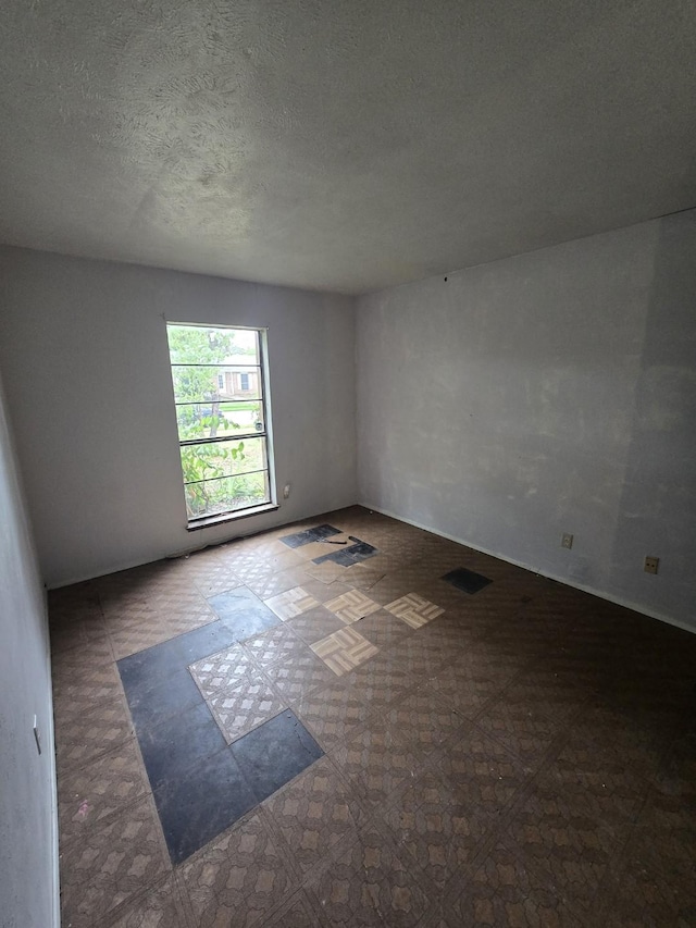 3706 Greenhill Ln, Grand Prairie, TX 75052 - empty room with tile patterned floors and a textured ceiling