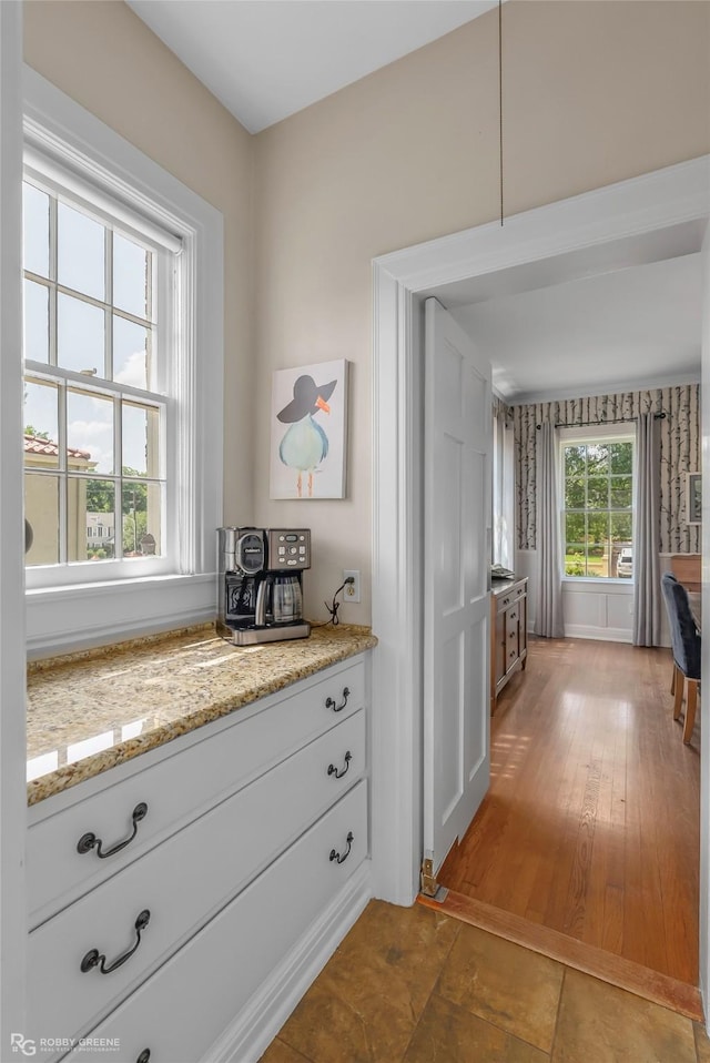 539 Atkins Ave, Shreveport, LA 71104 - kitchen with light stone countertops and white cabinetry