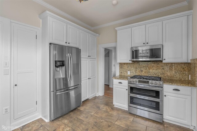 539 Atkins Ave, Shreveport, LA 71104 - kitchen featuring appliances with stainless steel finishes, ornamental molding, white cabinetry, light stone counters, and tasteful backsplash