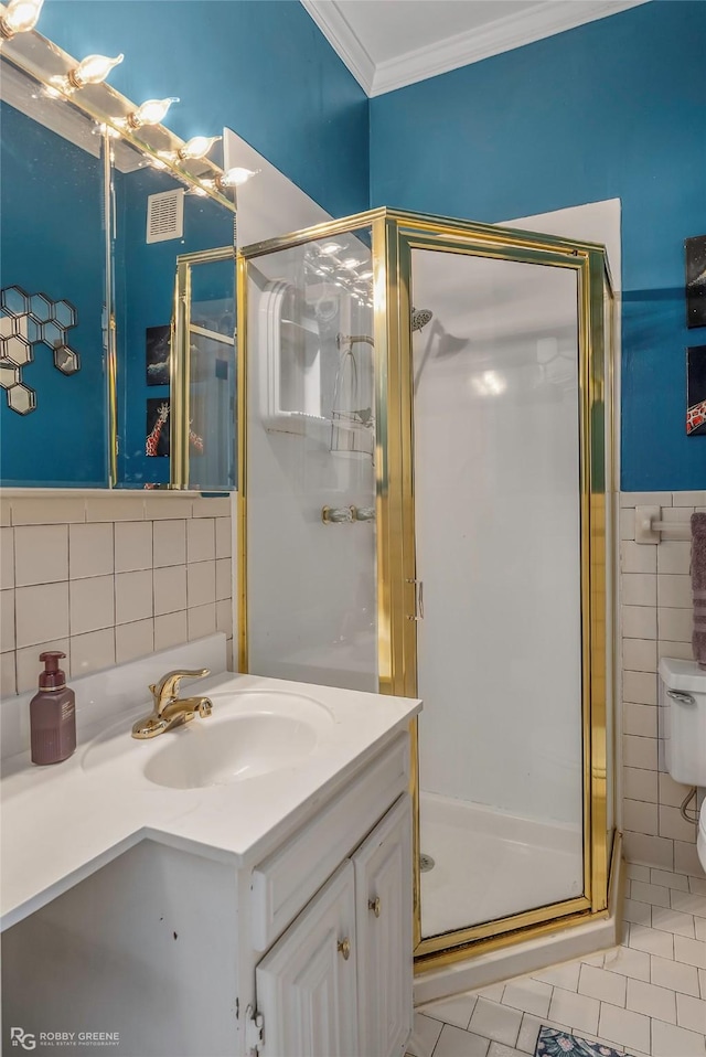 539 Atkins Ave, Shreveport, LA 71104 - bathroom featuring tile walls, vanity, a stall shower, tile patterned floors, and ornamental molding