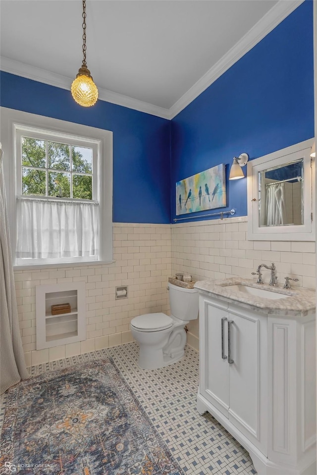 539 Atkins Ave, Shreveport, LA 71104 - bathroom with vanity, tile walls, wainscoting, and ornamental molding