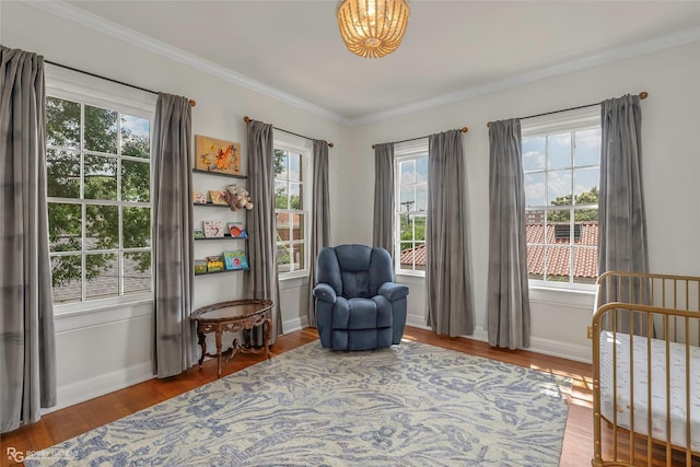 539 Atkins Ave, Shreveport, LA 71104 - living area with wood finished floors, healthy amount of natural light, crown molding, and a chandelier