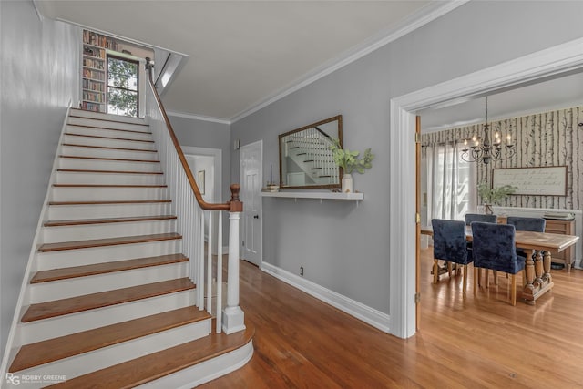 539 Atkins Ave, Shreveport, LA 71104 - staircase with a chandelier, wood finished floors, and crown molding