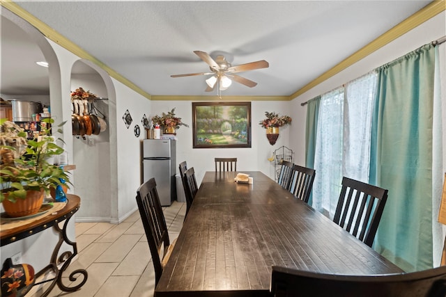 3440 Baby Doe Ct, Fort Worth, TX 76137 - dining room with a ceiling fan, arched walkways, light tile patterned floors, and crown molding