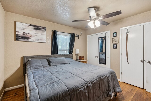 1321 S Lamar St, Weatherford, TX 76086 - bedroom featuring hardwood / wood-style floors, a textured wall, ceiling fan, two closets, and a textured ceiling