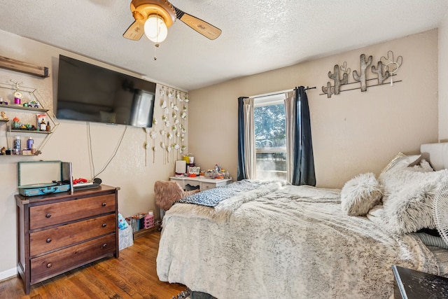 1321 S Lamar St, Weatherford, TX 76086 - bedroom with wood finished floors, a textured ceiling, and a ceiling fan